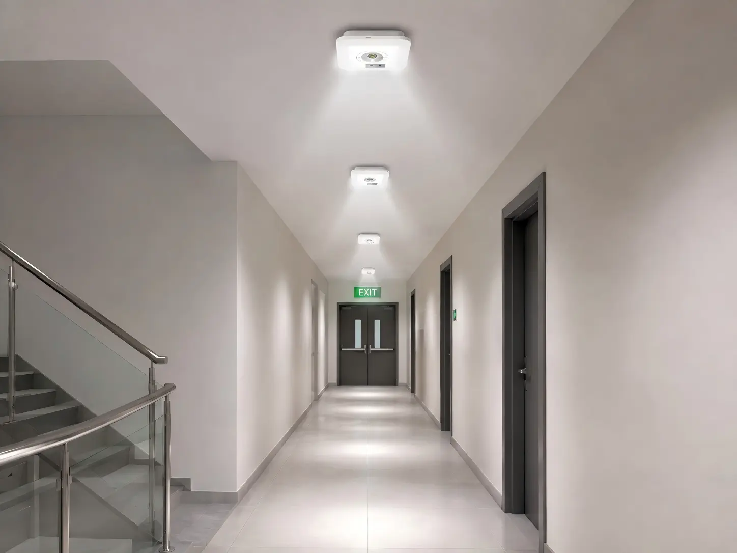 IP65 LED emergency light with corridor lens installed along an indoor escape route