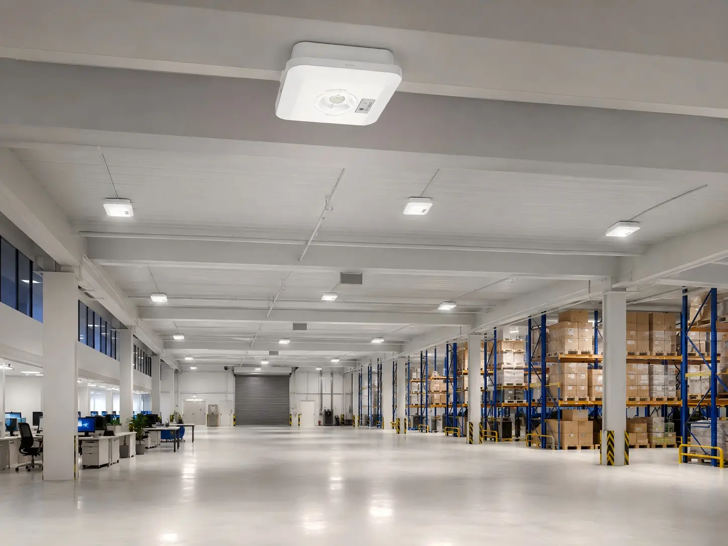 IP65 LED emergency light with open-area lens installed in a large warehouse